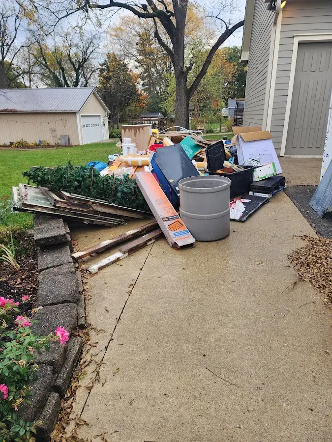 Dumpster being loaded with debris for Estate Cleanout Dumpster Rental in Caernarvon